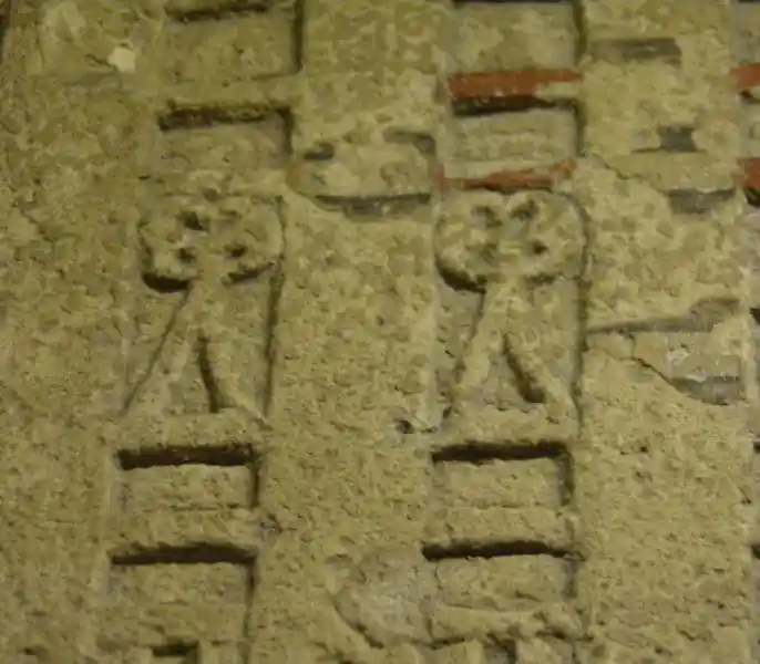 Four-point flower-like symbol on top a triangle